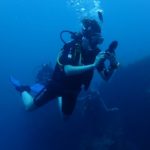 Diver checking SPG during PADI open water diving course in Tulamben, Bali, Indonesia