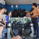 Divers receive a pre-dive instructional briefing in Tulamben Bali