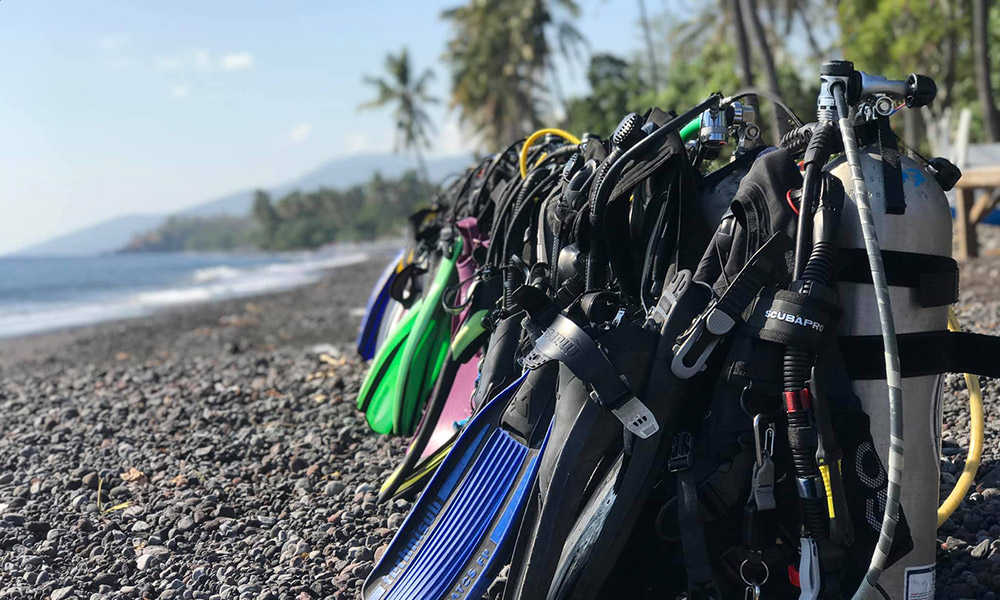 Scuba gear lined up along the beach in Tulamben, Bali